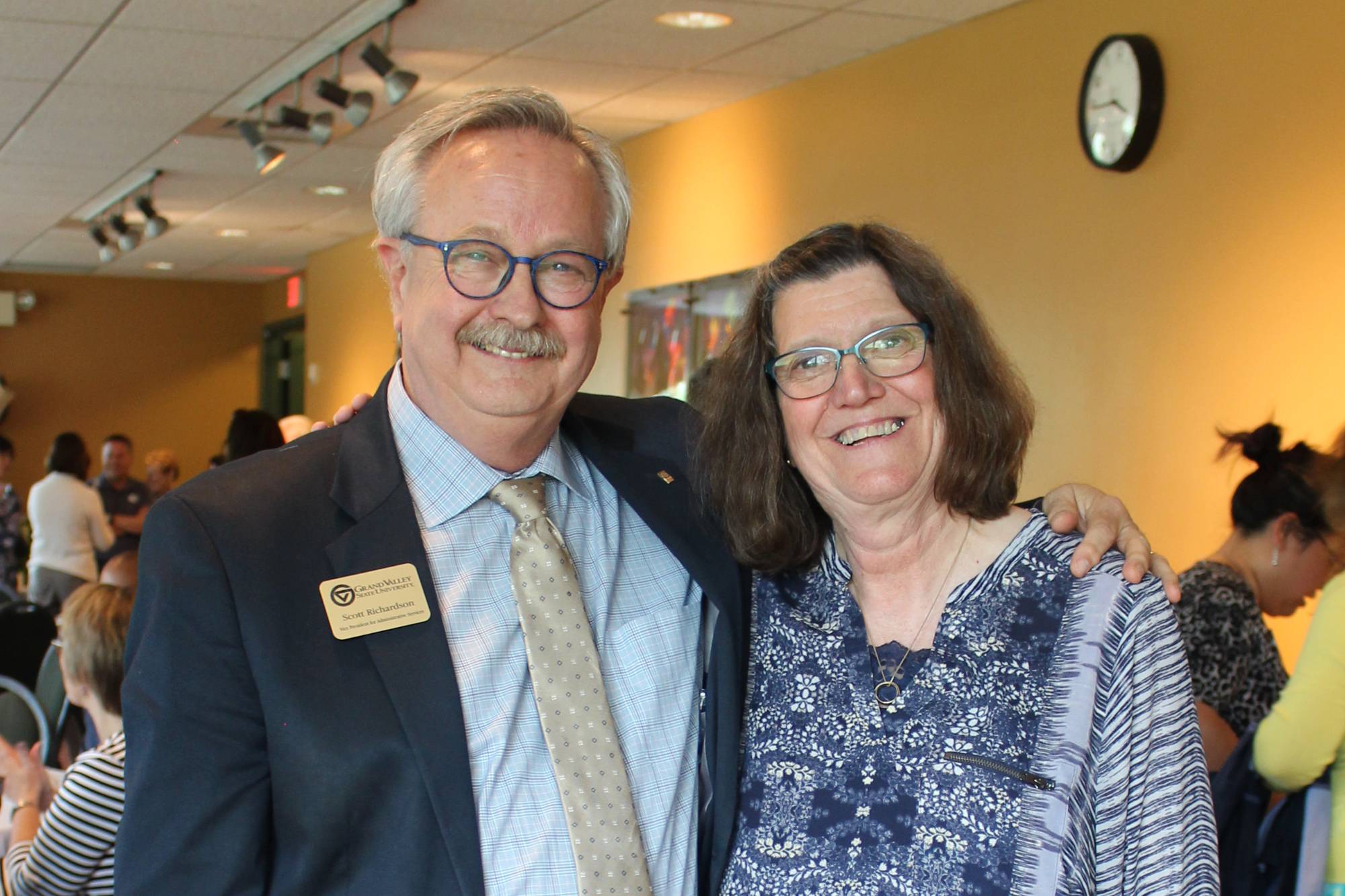 Photo of two GVSU retirees, Scott Richardson and Bonnie Maka, smiling with their arms around each other